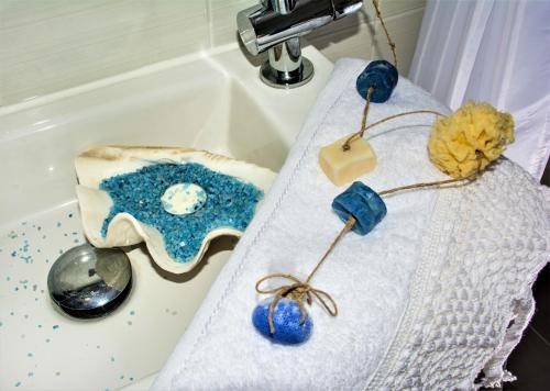a sink with a table with a blue and white cloth at Estia guest house in Olympia