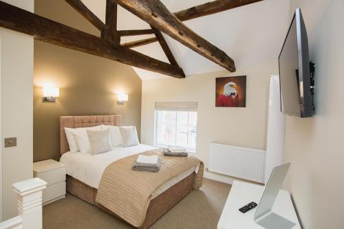 a bedroom with a bed and a tv and a desk at THE SPREAD EAGLE chesterfield in Chesterfield