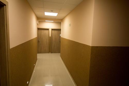 a hallway with a row of lockers in a building at M7 Galéria Panzió in Letenye