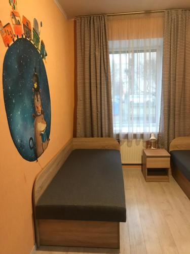 a bedroom with a bed in the corner of a room at DAUGAVPILS in Daugavpils