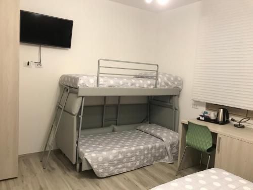 a room with two bunk beds and a desk at Il Sole e la Luna B&B in Garda in Garda