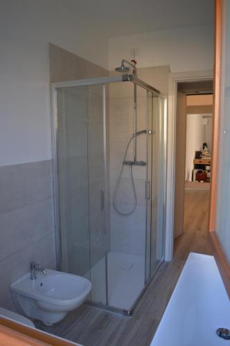 a bathroom with a shower and a toilet at Il Sole e la Luna B&B in Garda in Garda