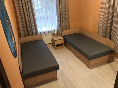 a small room with a bed and a window at DAUGAVPILS in Daugavpils