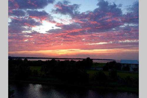 a sunset over a body of water with the sky at 115 Harbour Key Drive in Harbor Island