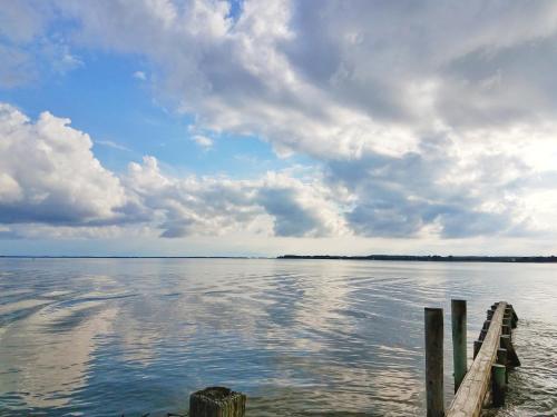 a view of a body of water with a pier at Sandaway Suites & Beach in Oxford