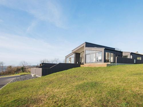 a house on top of a grassy hill at 6 person holiday home in Aabenraa in Aabenraa