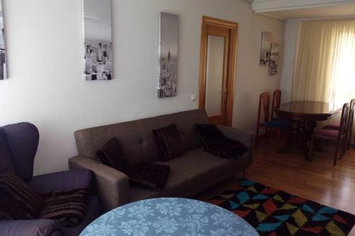 a living room with a couch and a table at APARTAMENTO CONGRESO in Logroño