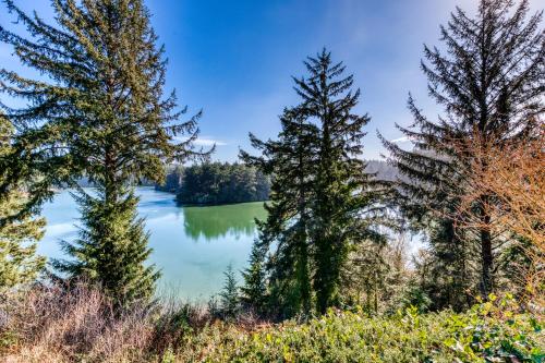 a view of a lake between two trees at Osprey Cove in Barview
