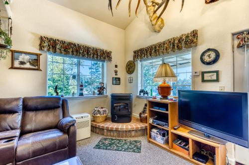 a living room with a tv and a couch and a chair at Osprey Cove in Barview