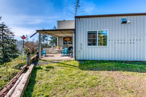 a small house with a deck and a patio at Osprey Cove in Barview
