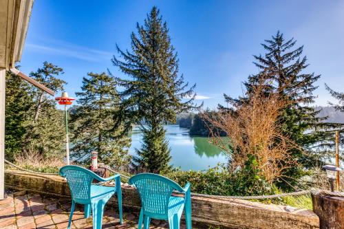 two chairs on a patio with a view of a lake at Osprey Cove in Barview