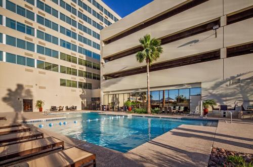 a swimming pool in front of a building at Crowne Plaza Phoenix Airport - PHX by IHG in Phoenix