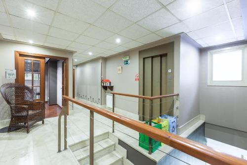 a hallway of a hospital with stairs and a window at Zumaia Hotela in Zumaia