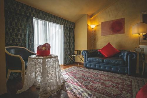 a living room with a couch and a table at Hotel Posta in Cecina