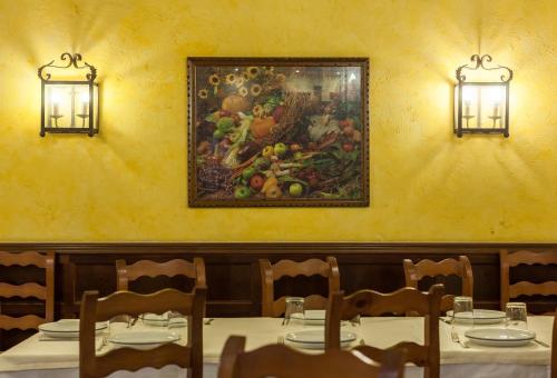 a table in a restaurant with a painting on the wall at Zumaia Hotela in Zumaia