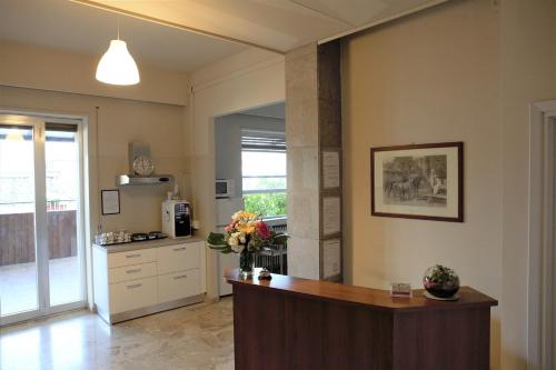 a kitchen with a white counter top and a large window at B&B Cameracaffè Centro in Arezzo