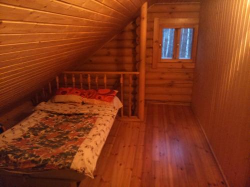 a bedroom with a bed in a log cabin at Kakulaane Tourism Farm in Lauküla