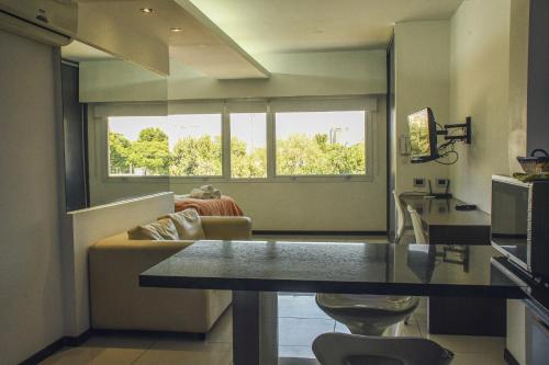 a kitchen and living room with a table and a couch at Guemes Apartment in San Juan