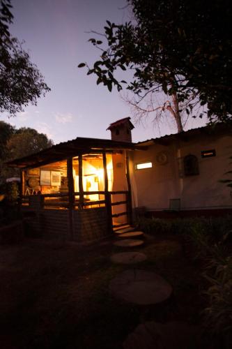 a small building with lights on in the dark at Htl & Villas Las Glorias Mazamitla, céntricas, parking, jardín in Mazamitla