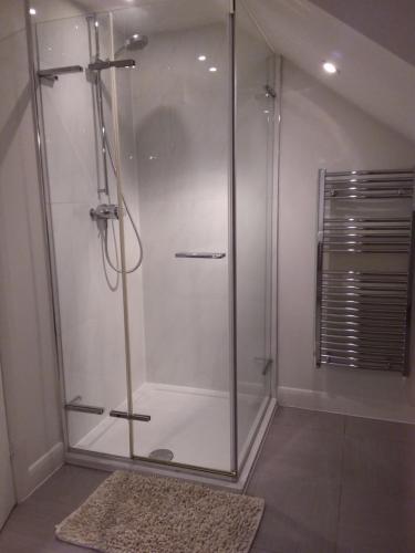 a shower with a glass door in a bathroom at Kneese Loft in Chesterfield