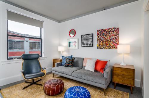 a living room with a couch and a chair at Norblad Hotel in Astoria, Oregon