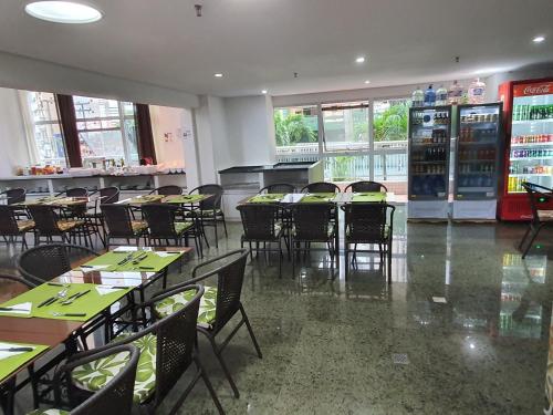 a dining room with tables and chairs in a restaurant at Beach Class Exclusive in Fortaleza