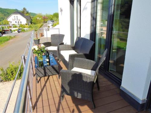 a row of chairs and a table on a balcony at Ferienwohnungen Krause in Cochem