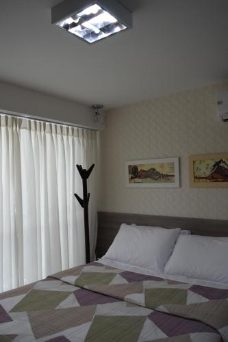 a bedroom with a bed and a window at Beach Class Exclusive in Fortaleza