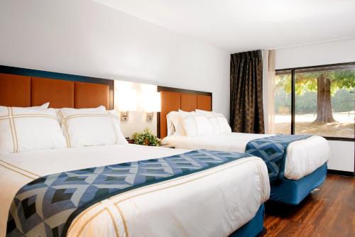 a hotel room with two beds and a window at Little Ocmulgee State Park and Lodge in McRae