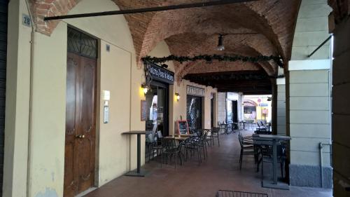 a hallway with tables and chairs in a building at Appartamenti i Liutai in Cremona