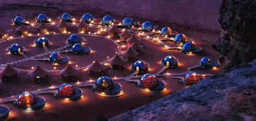 an overhead view of a group of lodges with lights at Memories Aicha Luxury Camp in Wadi Rum