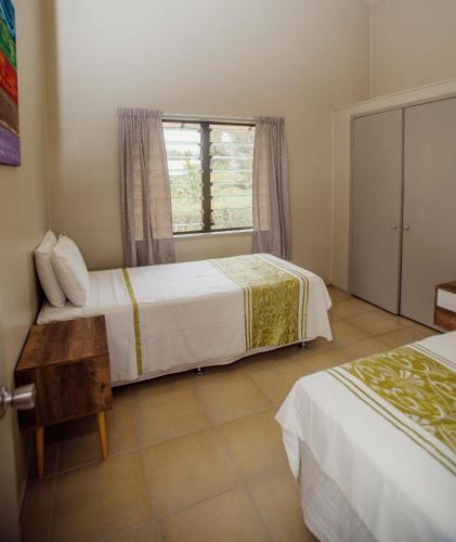 Voodi või voodid majutusasutuse Nikao Beach Bungalows toas