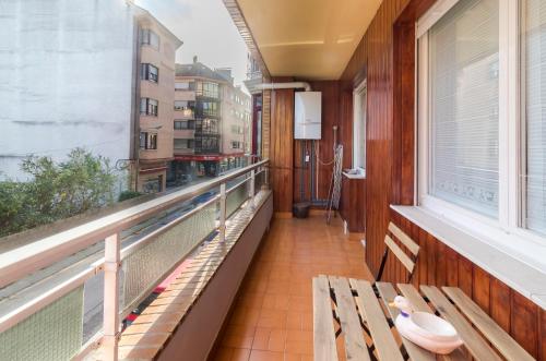 a balcony with a bench and a window at Apartamento Vital Aza in Pola de Lena