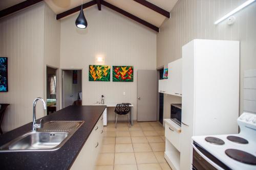 a kitchen with a sink and a counter top at Nikao Beach Bungalows in Rarotonga