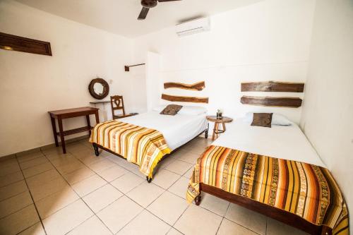 Posteľ alebo postele v izbe v ubytovaní Hotel el Manglar