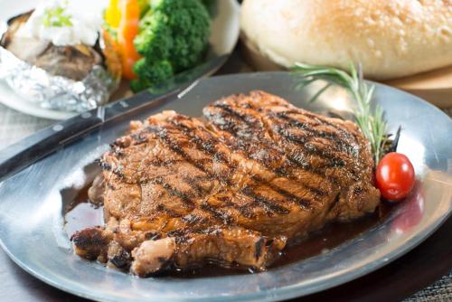 a plate of meat and vegetables on a table at Crowne Plaza Saddle Brook by IHG in Saddle Brook