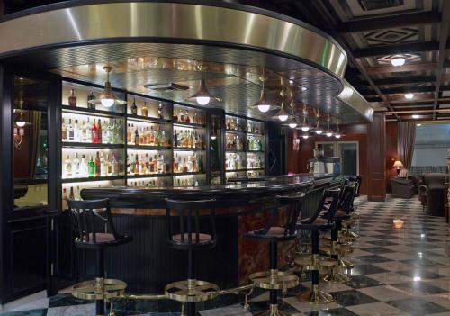 a bar with a bunch of bar stools at Samaria Hotel in Chania Town