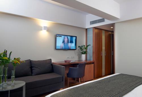 a living room with a couch and a desk at Samaria Hotel in Chania Town