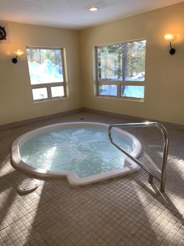 a bath tub sitting in the middle of a room at Glacier Mountain Lodge in Blue River