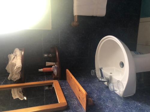 a bathroom with a white toilet and a mirror at Belle vue in La Trinité