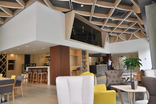 a restaurant with a coffered ceiling and tables and chairs at Hotel Nox in Ljubljana