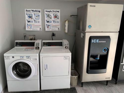 a laundry room with a washer and a refrigerator at SureStay Hotel By Best Western Olathe in Olathe