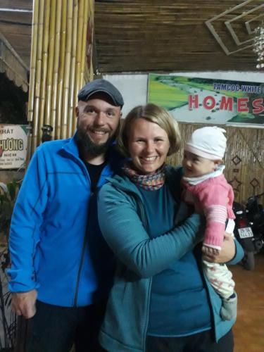 a man and a woman holding a baby at Tam Coc White Swan Homestay in Ninh Binh
