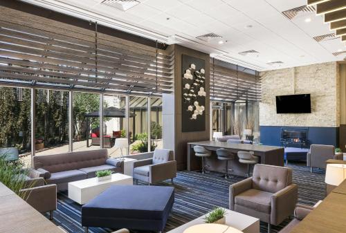 a lobby with couches and a bar in a building at Best Western Premier Calgary Plaza Hotel & Conference Centre in Calgary