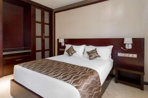 a bedroom with a large bed and a television at Best Western Plus Pearl Addis in Addis Ababa
