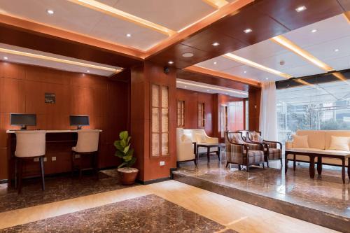 an office lobby with a desk and chairs at Best Western Plus Pearl Addis in Addis Ababa