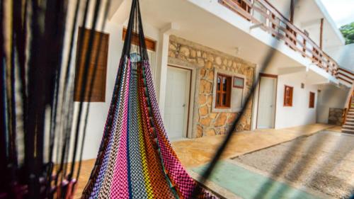 a room with a hanging hammock in a house at Hotel el Manglar in Bacalar