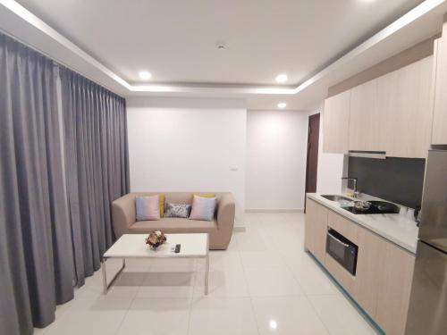 a living room with a couch and a table at 2BDR in Water Resort close to WalkingStreet in Pattaya South