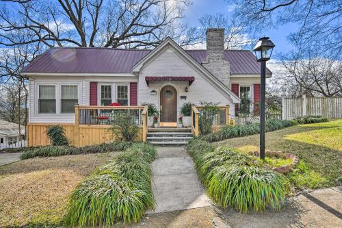 a white house with a porch and a driveway at 2 Mi to Oaklawn Casino Home with Peaceful Yard! in Hot Springs