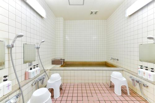 a bathroom with two toilets and a bath tub at G-SQUARE in Yamagata